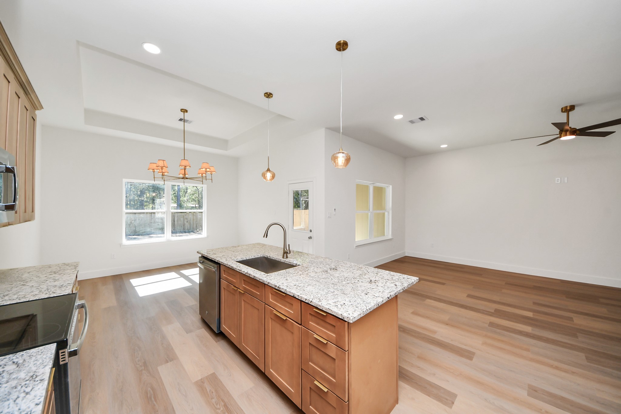 16276 Jeet Street Conroe, TX 77306 - Photo 11 of 36 a kitchen with a sink stove and wooden cabinets