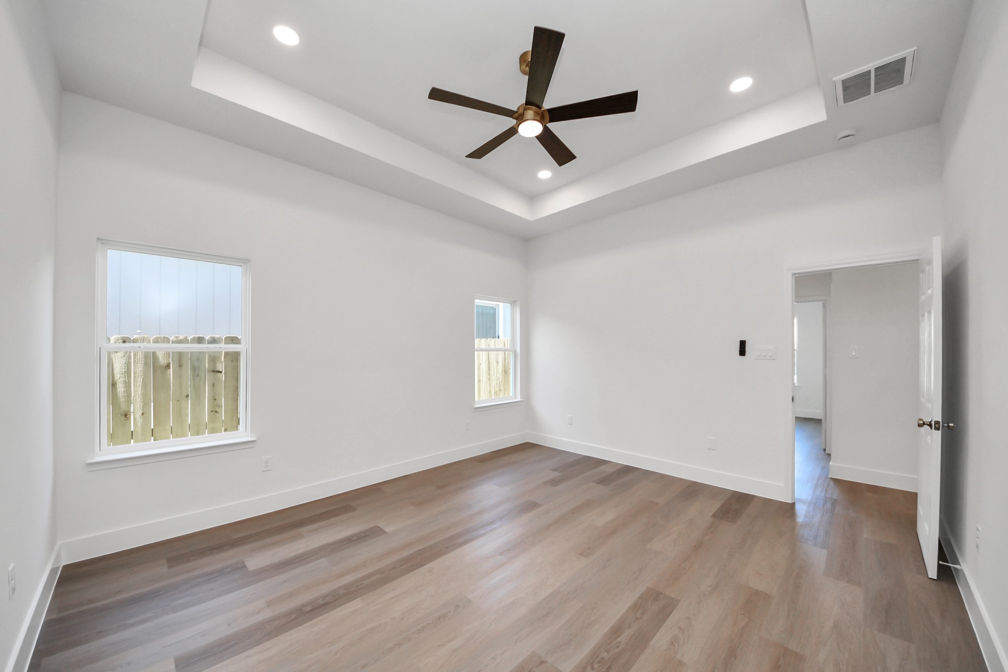 16276 Jeet Street Conroe, TX 77306 - Photo 16 of 36 a view of empty room with wooden floor and ceiling fan