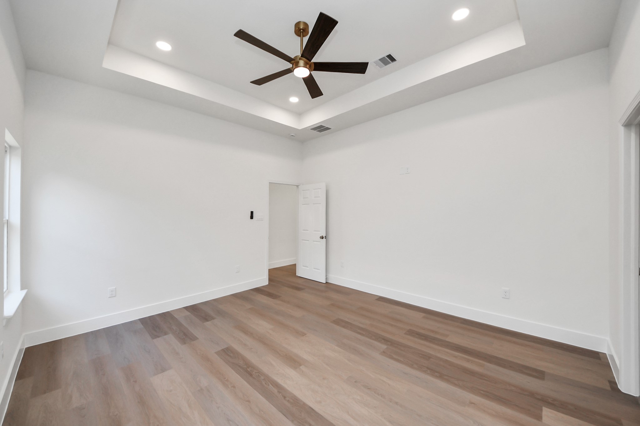 16276 Jeet Street Conroe, TX 77306 - Photo 17 of 36 an empty room with wooden floor and ceiling fan
