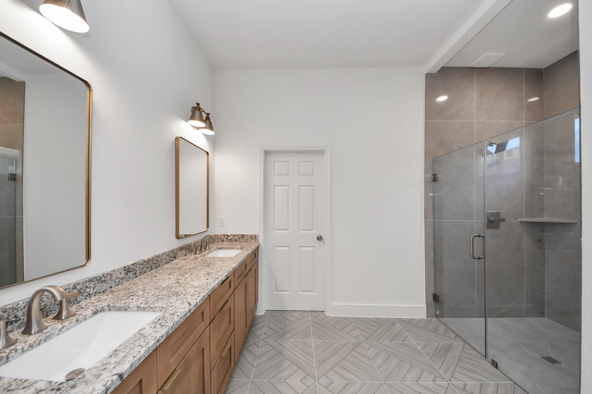 16276 Jeet Street Conroe, TX 77306 - Photo 18 of 36 a bathroom with a granite countertop sink a mirror and shower