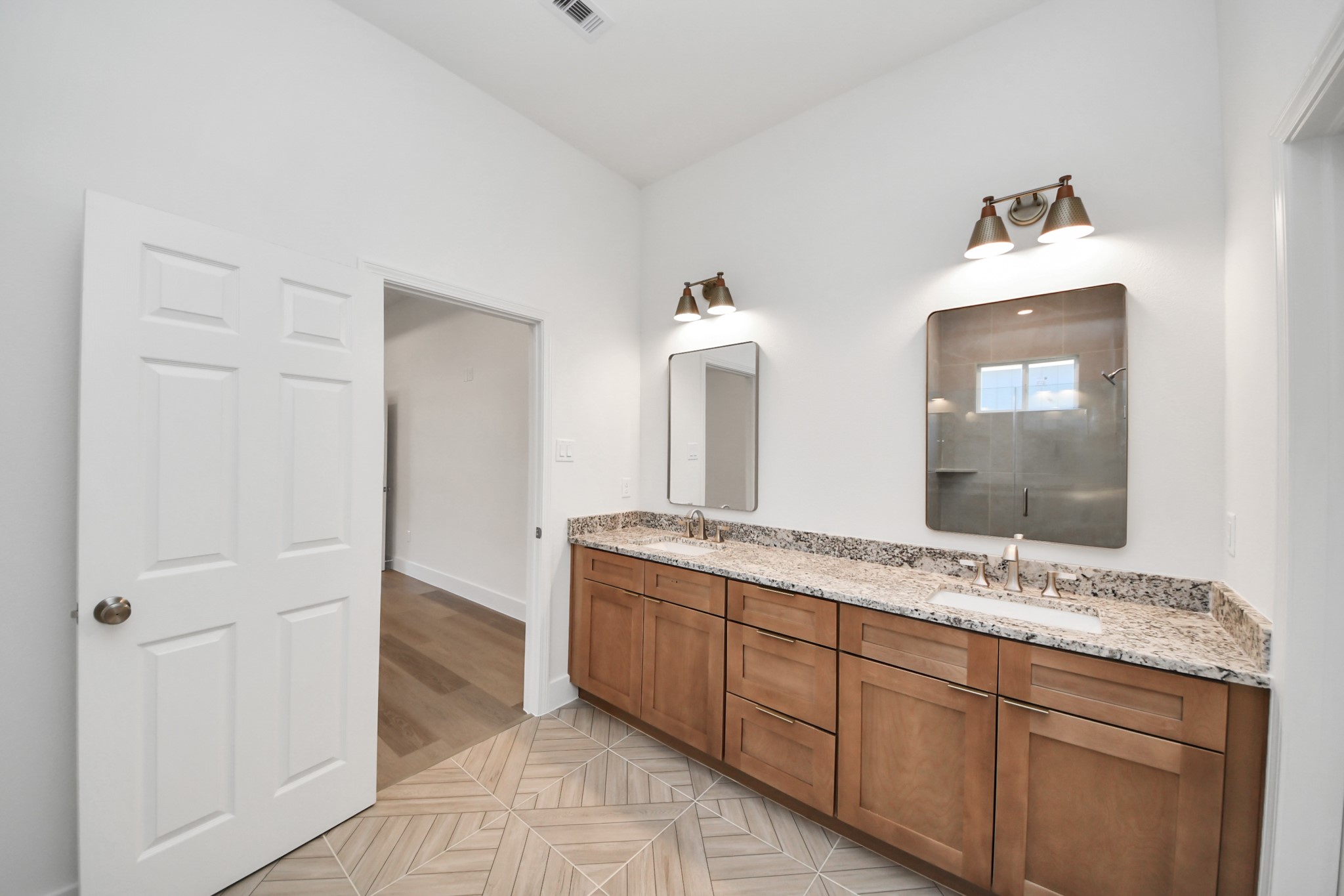 16276 Jeet Street Conroe, TX 77306 - Photo 20 of 36 a bathroom with a double vanity sink and a mirror