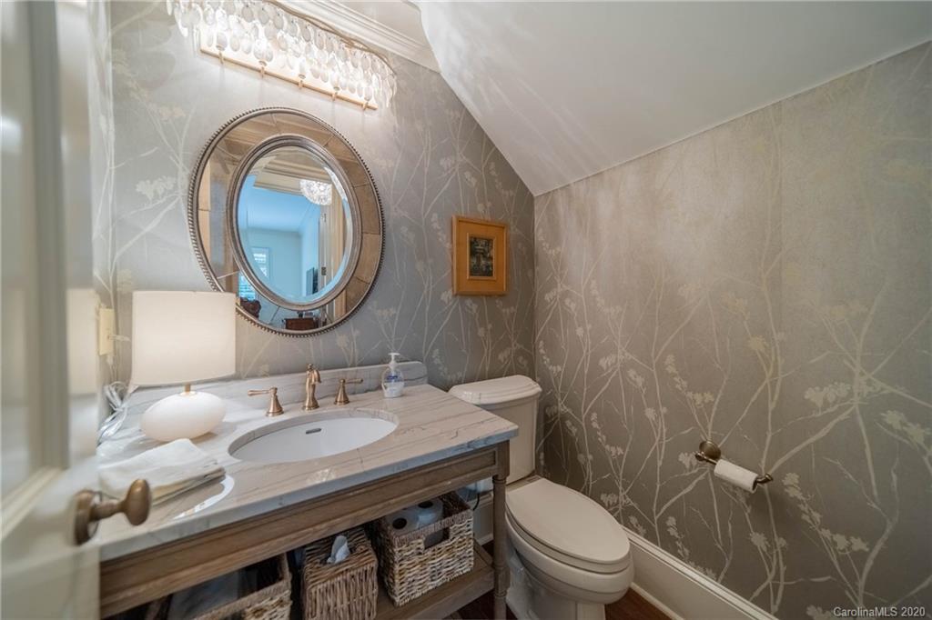 901 Colville Road Charlotte, NC 28207 - Photo 18 of 48 a bathroom with a sink a toilet and a mirror