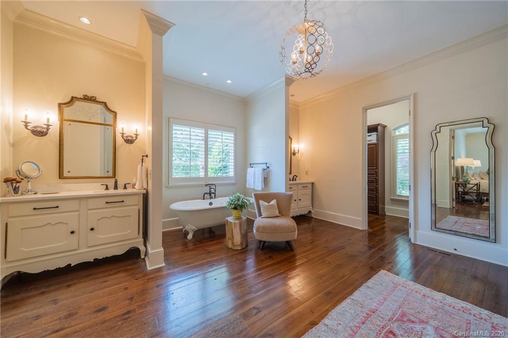 901 Colville Road Charlotte, NC 28207 - Photo 20 of 48 a room with lots of wooden furniture and a chandelier