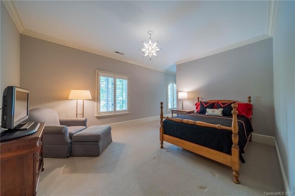 901 Colville Road Charlotte, NC 28207 - Photo 23 of 48 a bed room with a bed and a chandelier