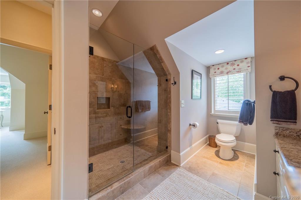 901 Colville Road Charlotte, NC 28207 - Photo 25 of 48 a bathroom with a toilet and a shower