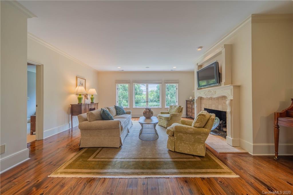 901 Colville Road Charlotte, NC 28207 - Photo 26 of 48 a living room with fireplace furniture and a wooden floor