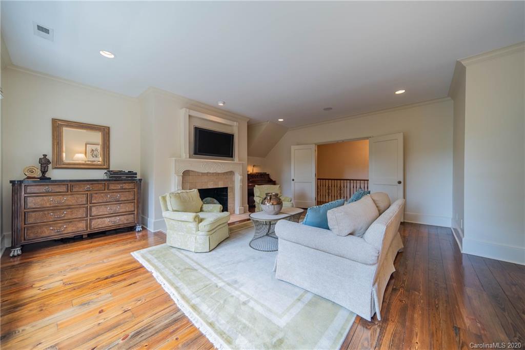 901 Colville Road Charlotte, NC 28207 - Photo 27 of 48 a living room with furniture a fireplace and a flat screen tv
