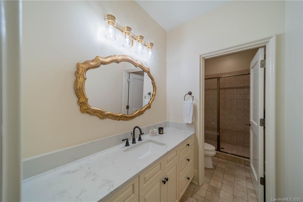 901 Colville Road Charlotte, NC 28207 - Photo 32 of 48 a bathroom with a sink and a mirror