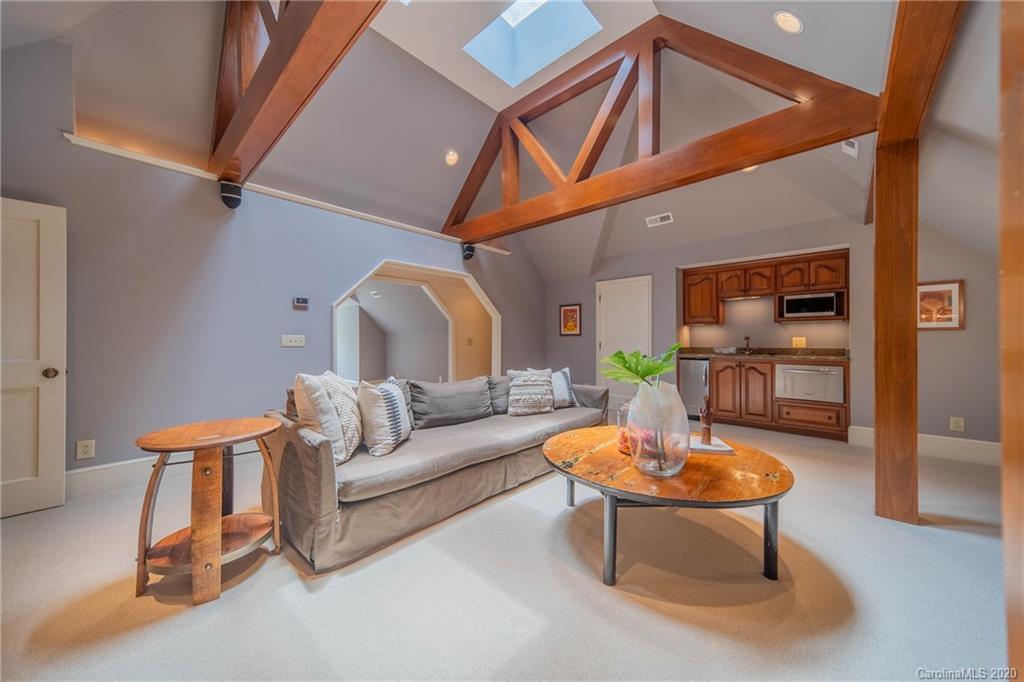 901 Colville Road Charlotte, NC 28207 - Photo 36 of 48 a living room with furniture a table and a potted plant
