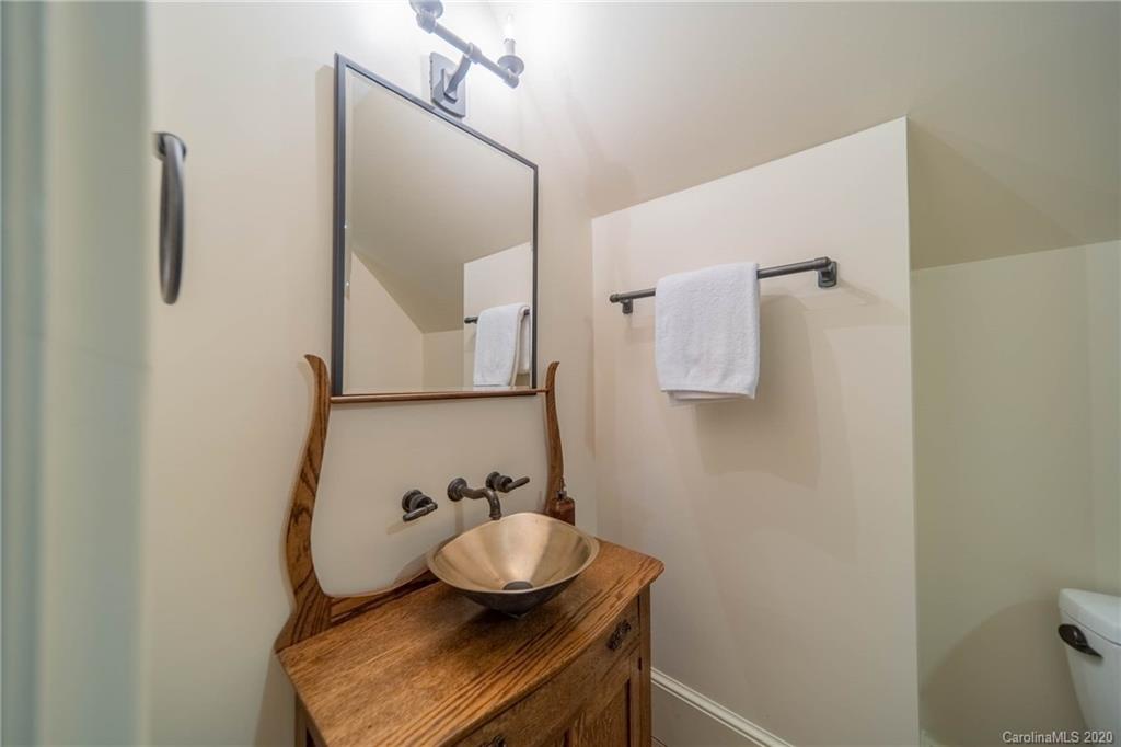 901 Colville Road Charlotte, NC 28207 - Photo 38 of 48 a bathroom with a sink and mirror