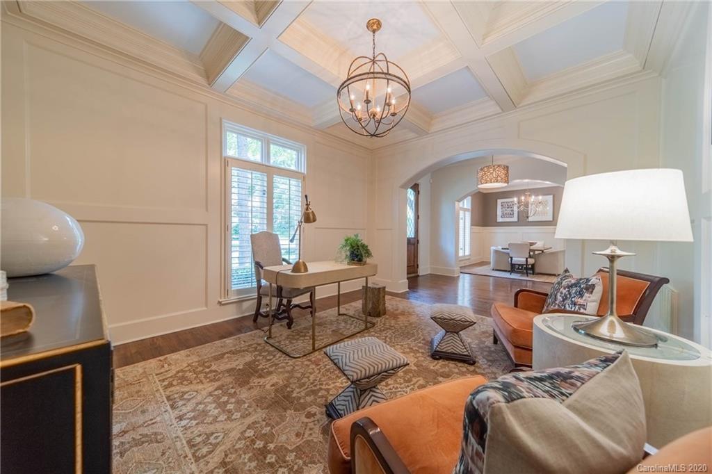 901 Colville Road Charlotte, NC 28207 - Photo 5 of 48 a living room with furniture a clock and a window