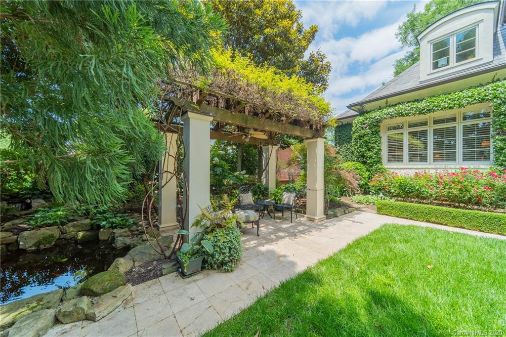 901 Colville Road Charlotte, NC 28207 - Photo 47 of 48 a backyard of a house with plants and outdoor seating