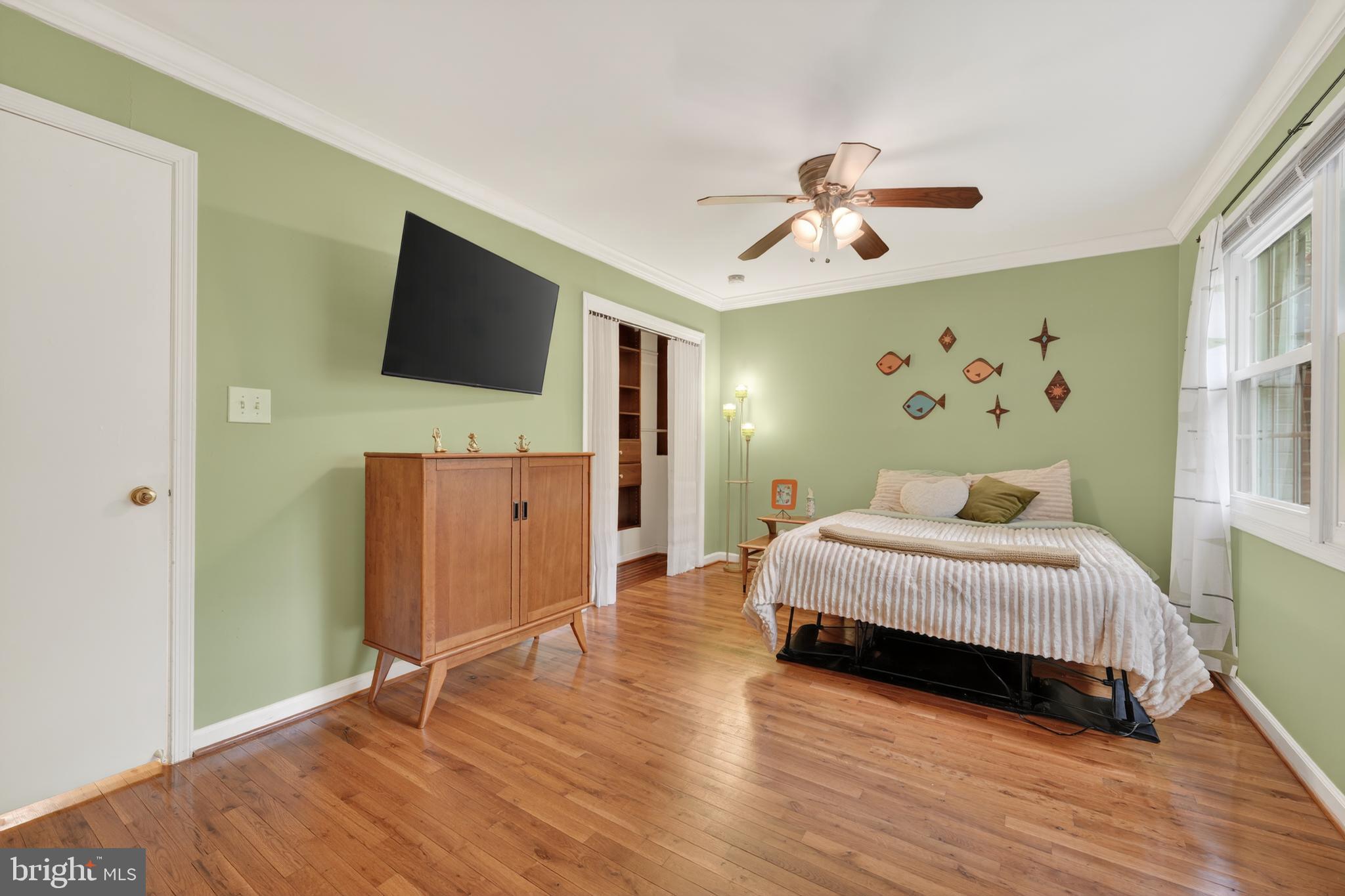 8139 Carrleigh Parkway Springfield, VA 22152 - Photo 23 of 27 a spacious bedroom with a bed and a flat screen tv