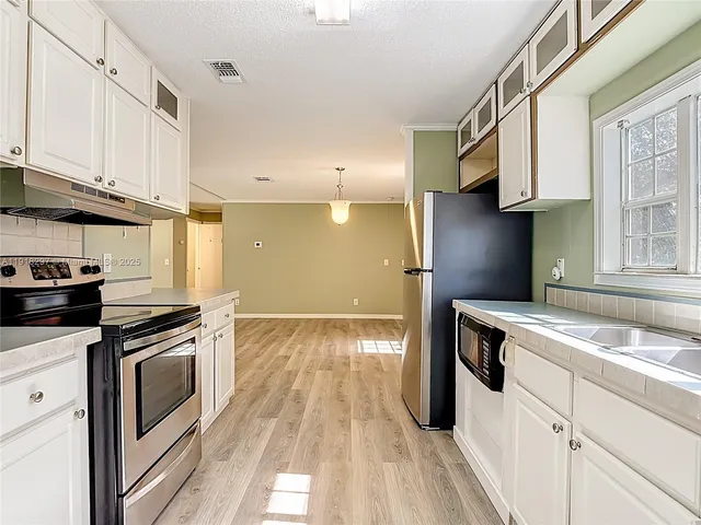 a kitchen with a stove and a sink