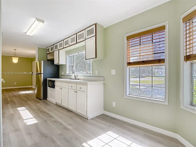 a bathroom with a sink shower and a mirror
