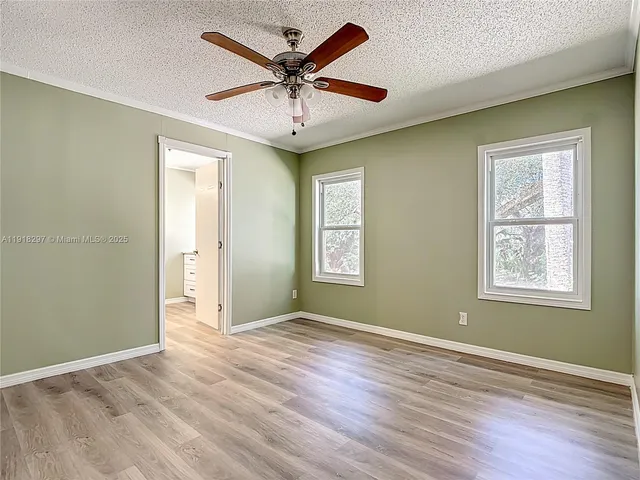 a view of room with window and wooden floor