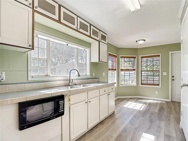 a view of a kitchen sink a dishwasher and a stove