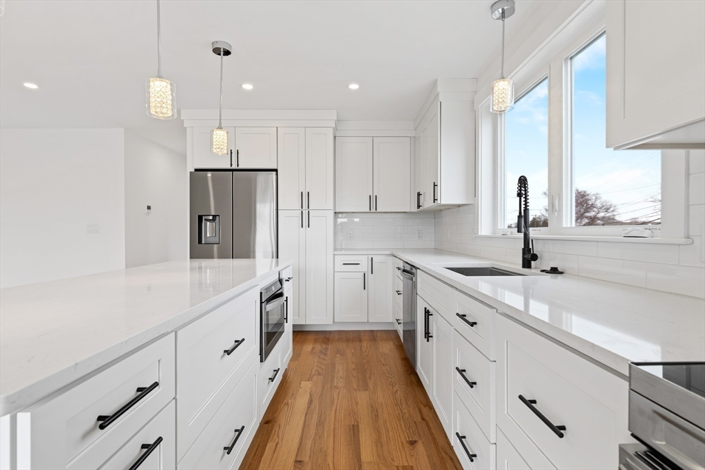 2 Old County Road, Unit 12 Salisbury, MA 01952 - Photo 5 of 29 a large kitchen with stainless steel appliances granite countertop a sink and cabinets