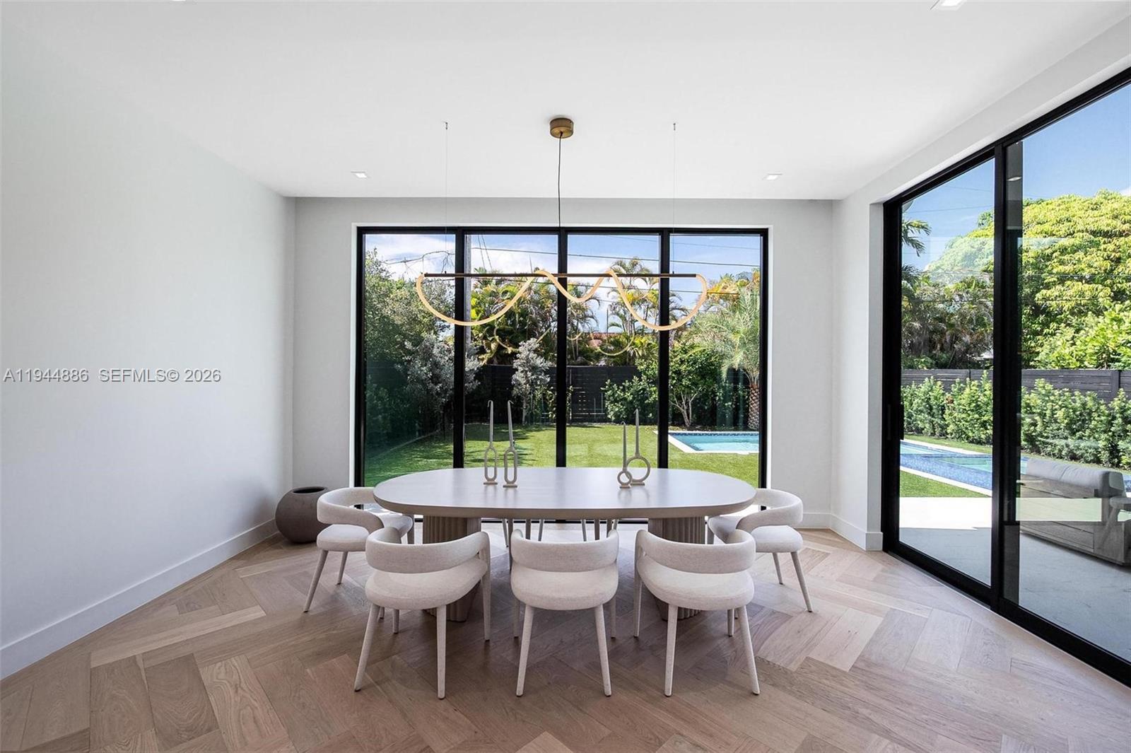 1344 Southwest 16th Street Miami, FL 33145 - Photo 4 of 37 a view of a dining room with furniture large windows and wooden floor