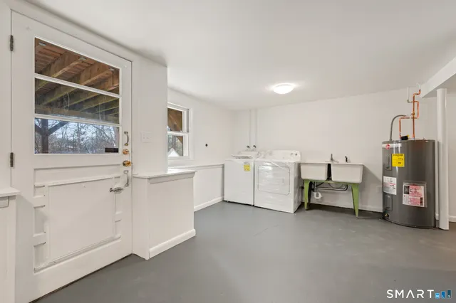 a utility room with cabinets dryer and washer