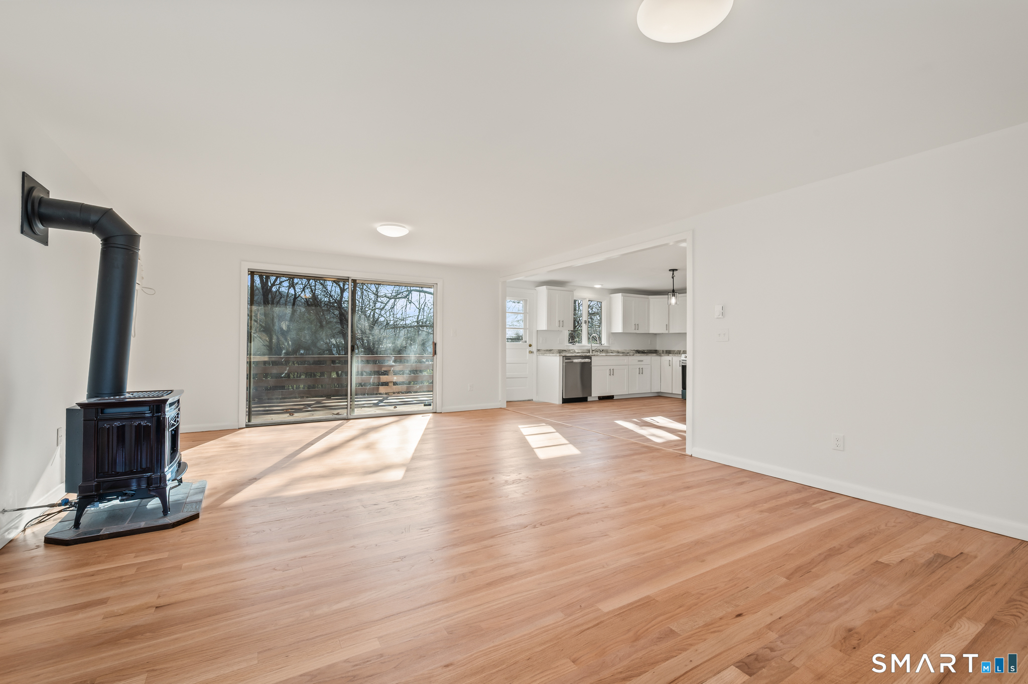 90 Pinnacle Road Plainville, CT 06062 - Photo 3 of 38 a view of empty room with wooden floor and fireplace