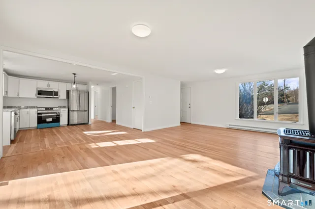 a view of a kitchen with a sink and a refrigerator