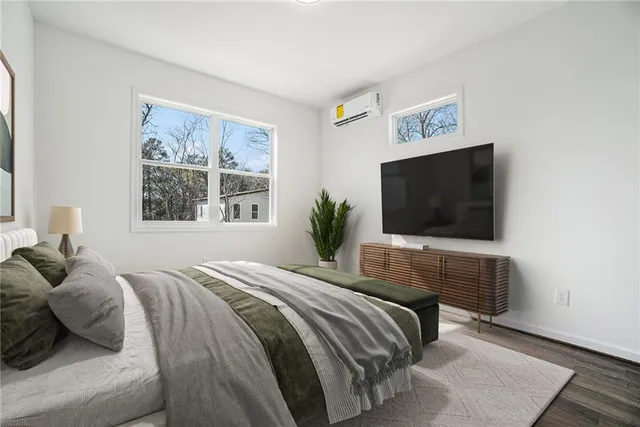 a bedroom with a bed and a television