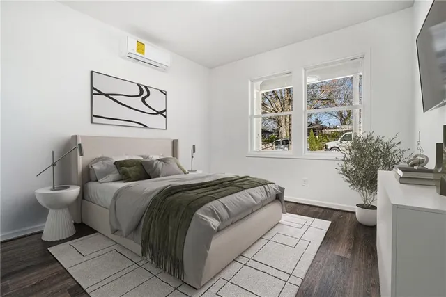 a bedroom with a bed and a painting on the wall