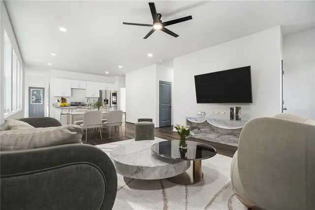a living room with furniture and a flat screen tv
