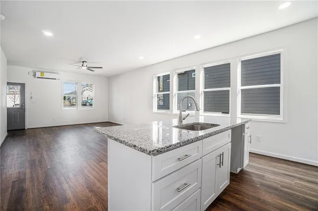 a kitchen with granite countertop a stove and a sink