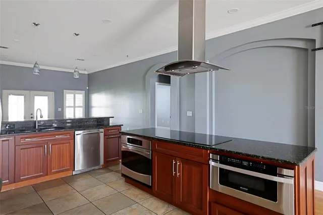 a kitchen with stainless steel appliances granite countertop a stove and a sink
