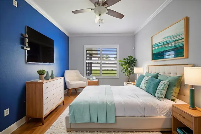 a bedroom with a large bed and a flat screen tv