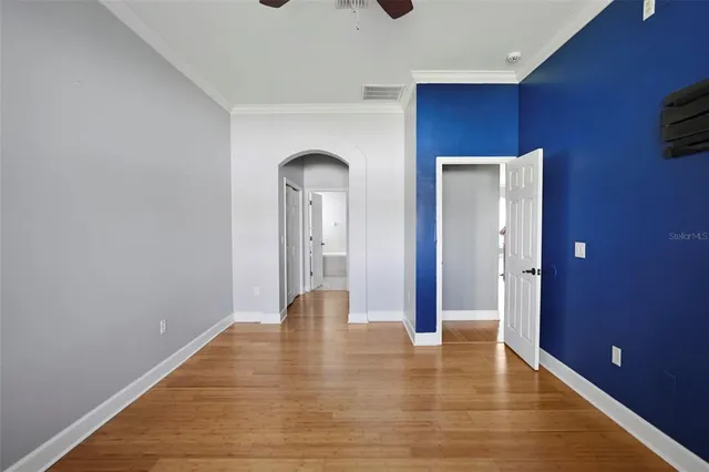 a view of empty room with wooden floor