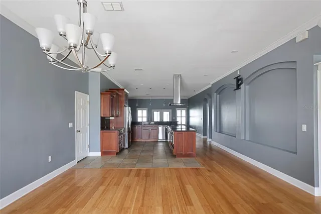 a view of a room with wooden floor