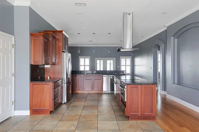 a kitchen with stainless steel appliances granite countertop a refrigerator and a stove