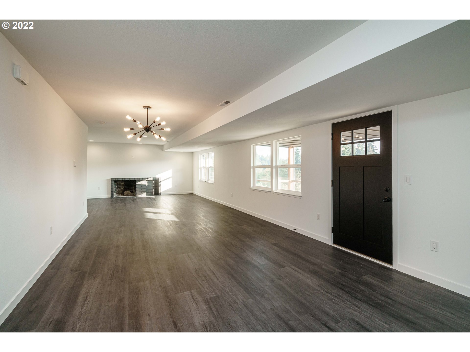 28371 Southeast KW Anderson Road Gresham, OR 97080 - Photo 12 of 32 a view of an empty room with wooden floor and a window
