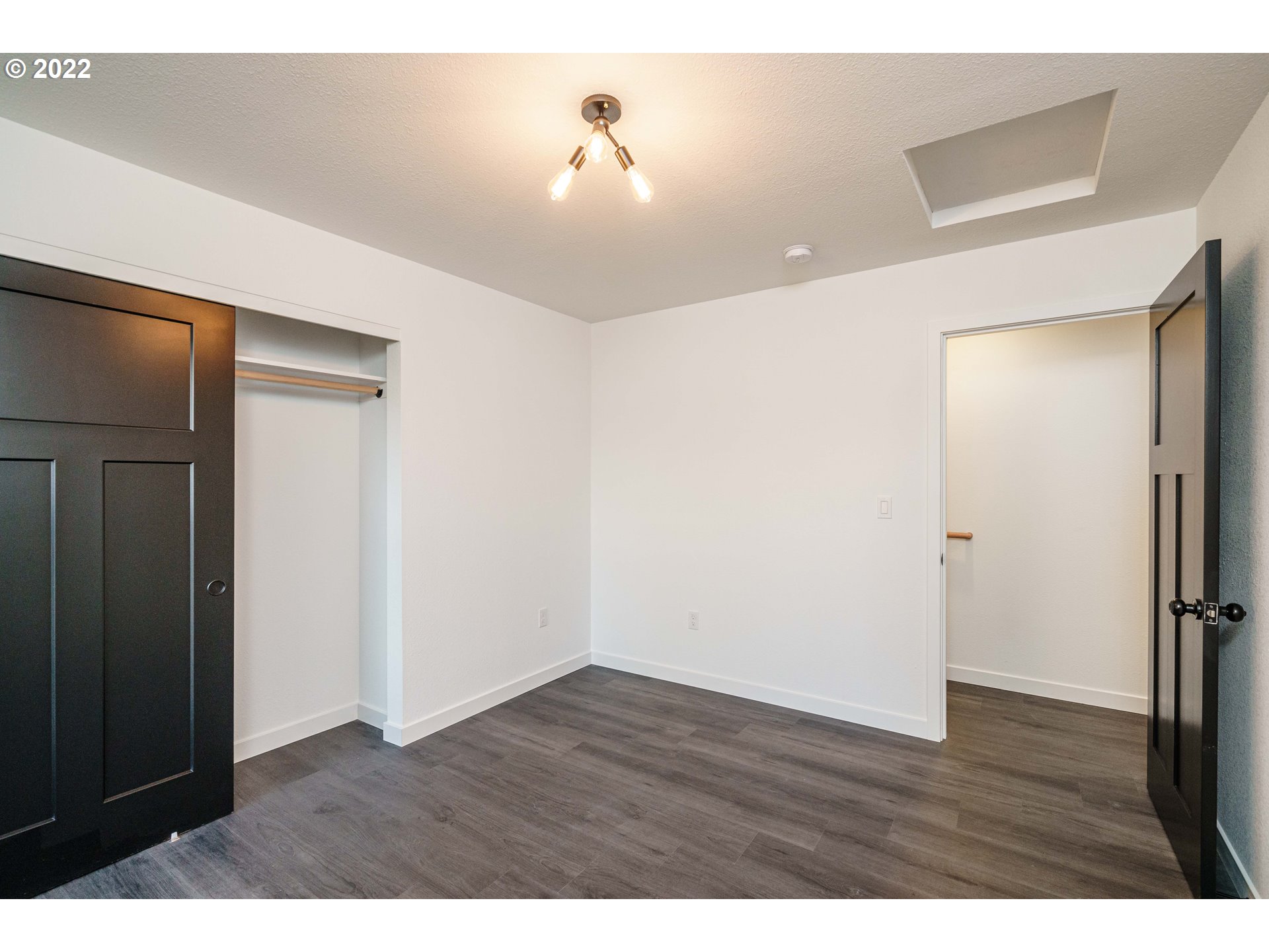 28371 Southeast KW Anderson Road Gresham, OR 97080 - Photo 18 of 32 a view of an empty room with wooden floor