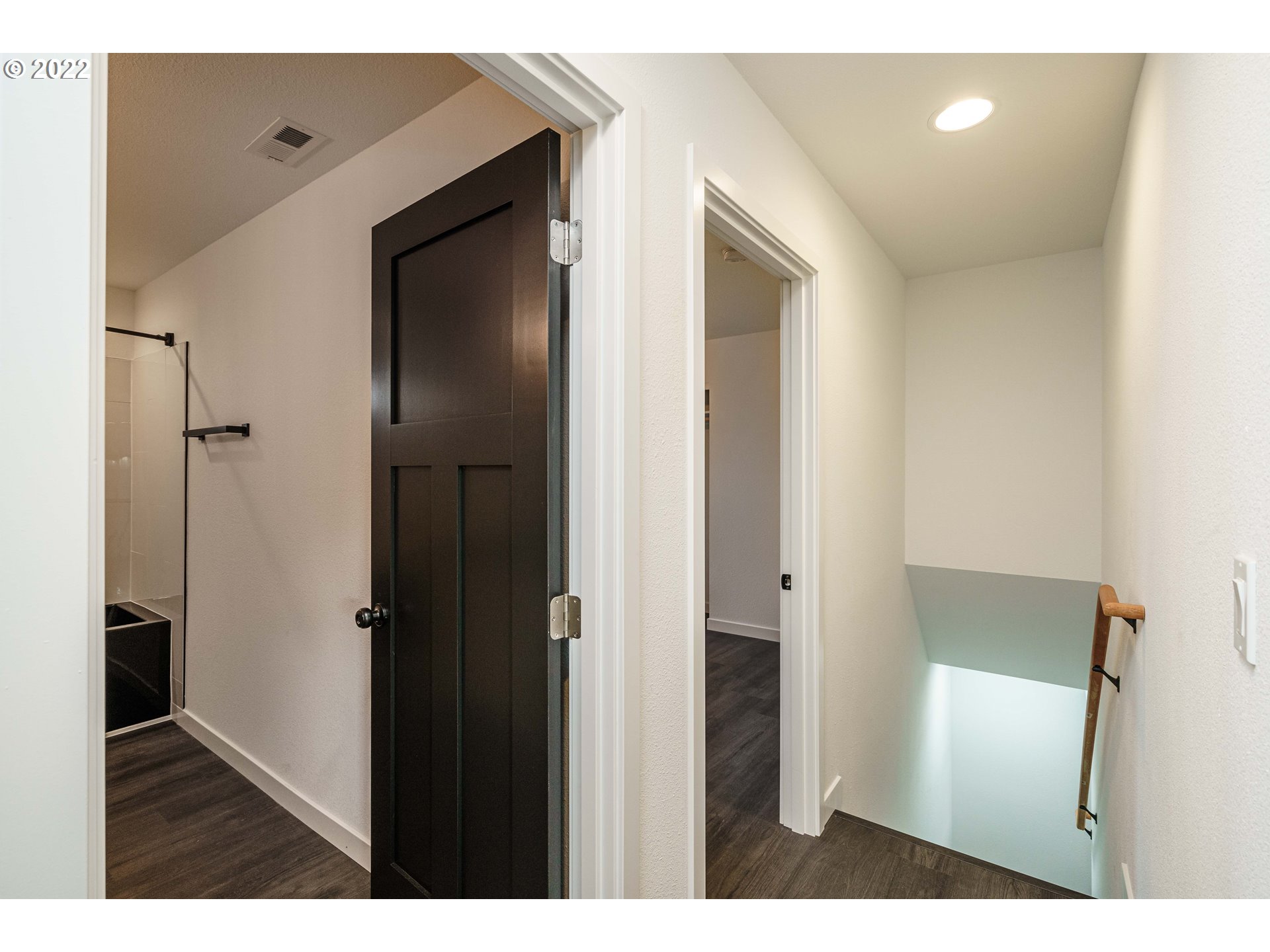 28371 Southeast KW Anderson Road Gresham, OR 97080 - Photo 20 of 32 a view of an empty room with wooden floor and a bathroom