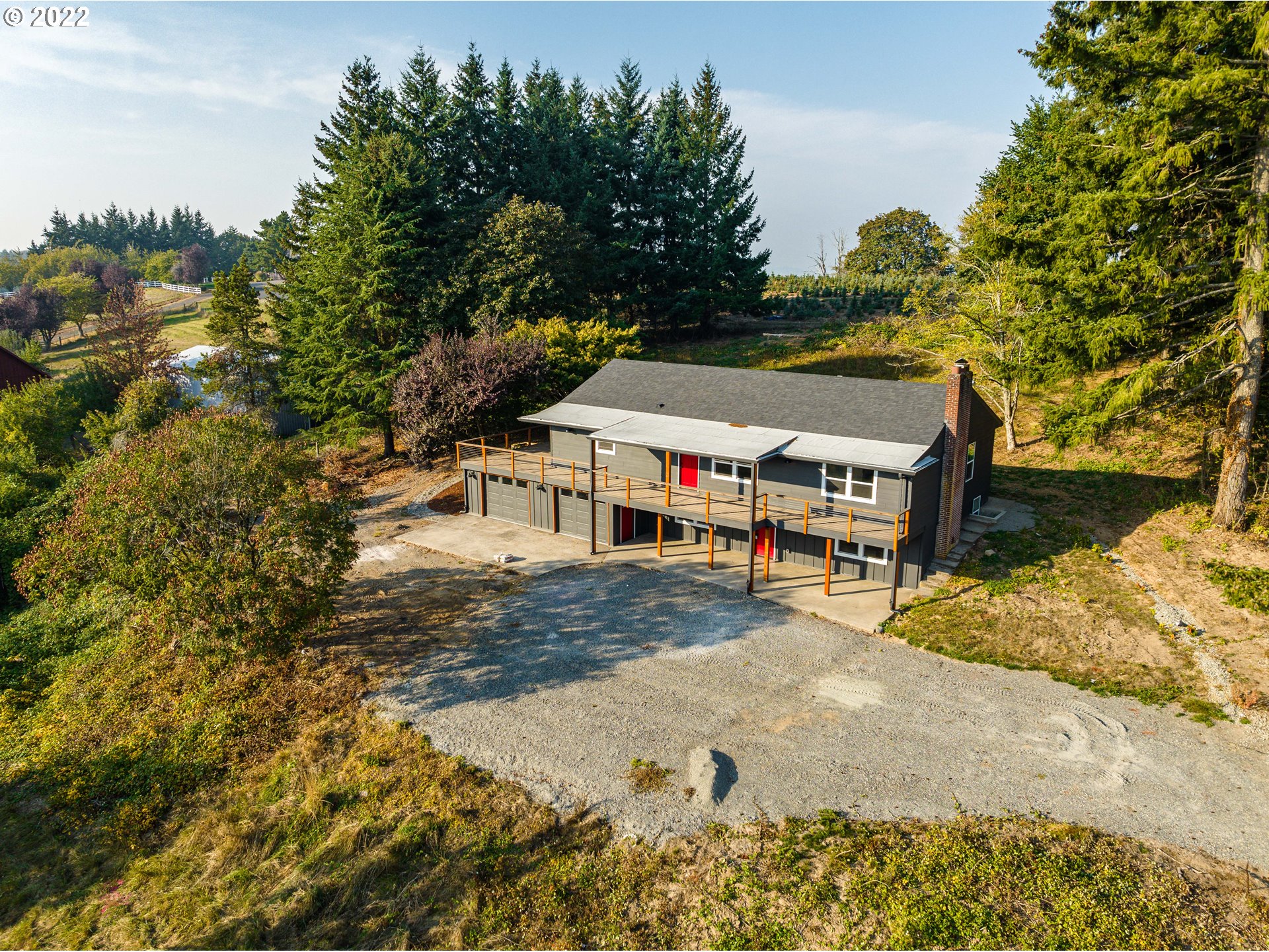 28371 Southeast KW Anderson Road Gresham, OR 97080 - Photo 29 of 32 a roof deck with table and chairs under an umbrella