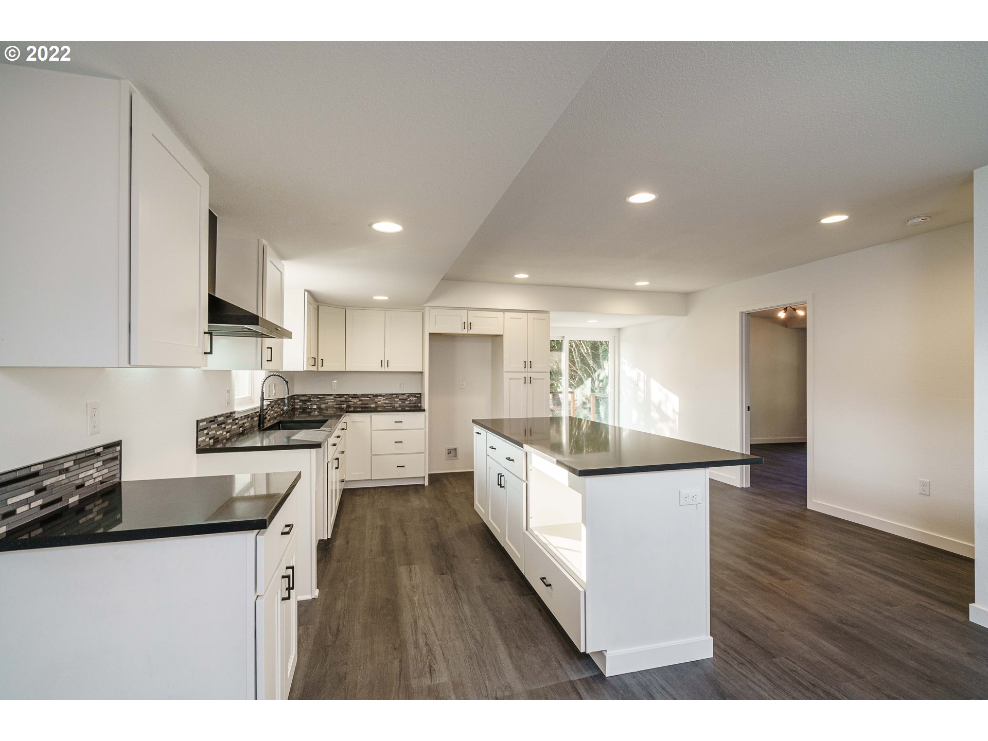 28371 Southeast KW Anderson Road Gresham, OR 97080 - Photo 8 of 32 a kitchen with stainless steel appliances kitchen island granite countertop a stove a sink a refrigerator and white cabinets with wooden floor