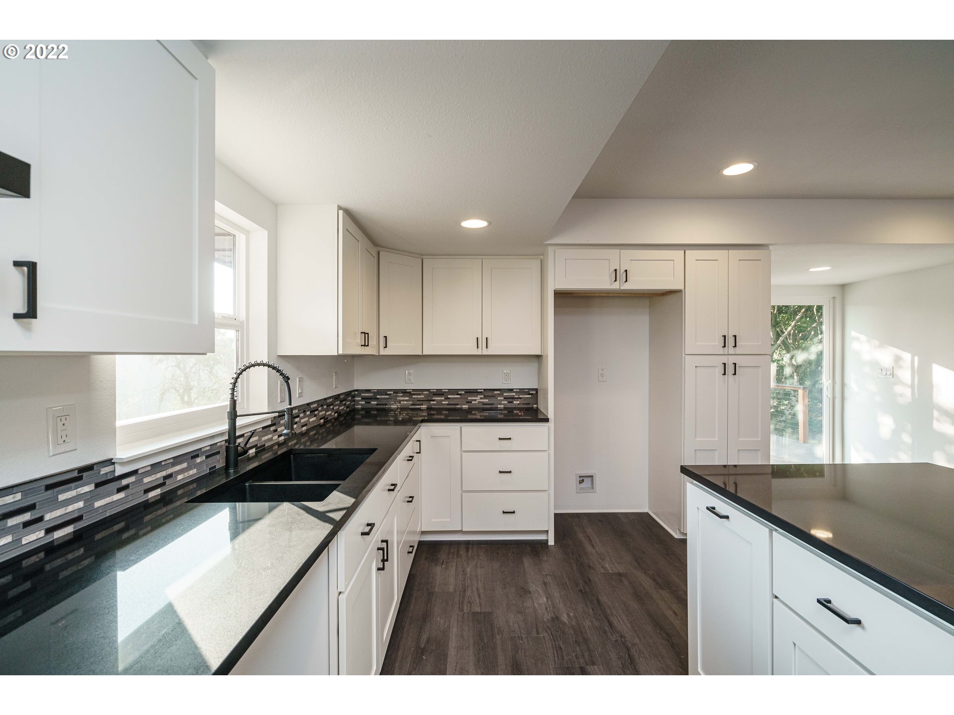 28371 Southeast KW Anderson Road Gresham, OR 97080 - Photo 9 of 32 a kitchen with granite countertop a stove a sink dishwasher and a refrigerator with wooden floor
