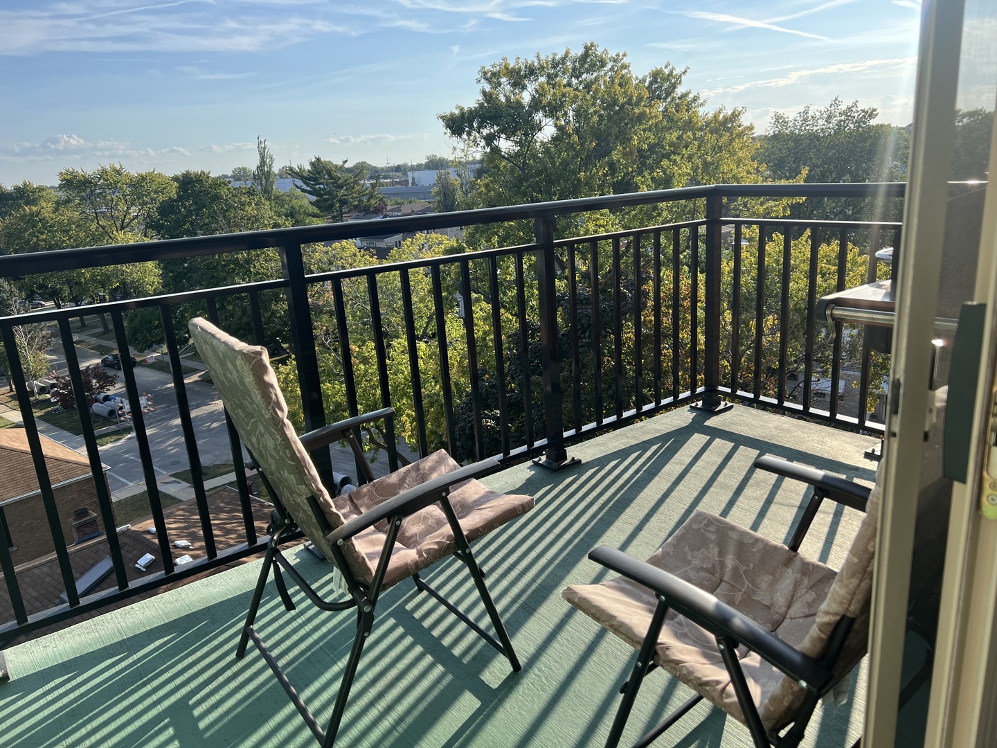 9355 Irving Park Road, Unit 522 Schiller Park, IL 60176 - Photo 17 of 24 a view of a balcony with wooden floor