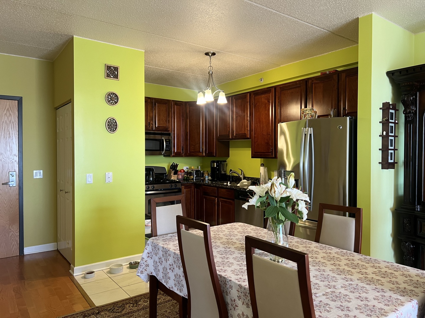9355 Irving Park Road, Unit 522 Schiller Park, IL 60176 - Photo 8 of 24 a dining room with stainless steel appliances granite countertop furniture and a chandelier