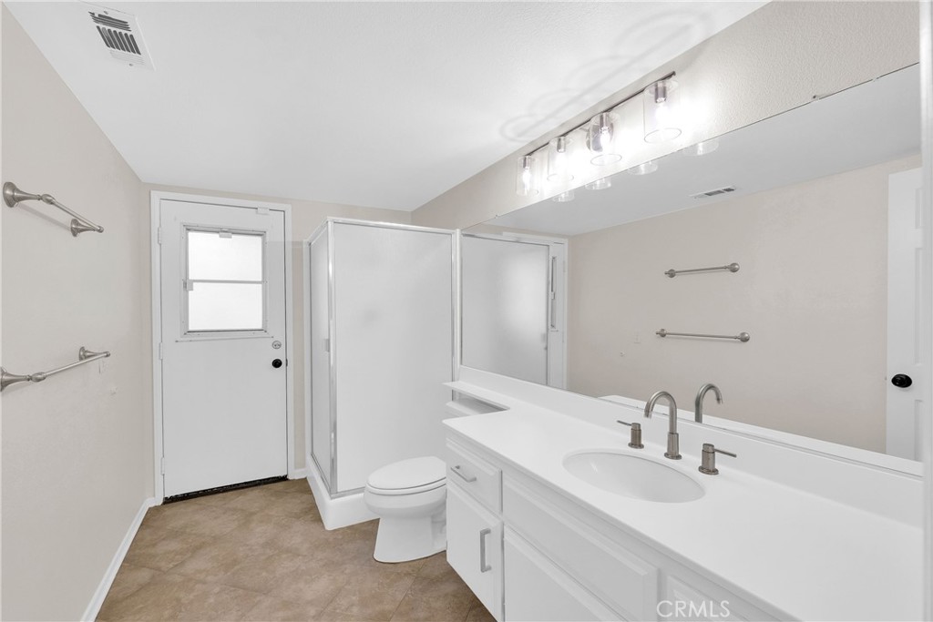 9253 Sunridge Drive Riverside, CA 92508 - Photo 22 of 54 a bathroom with a toilet sink and a mirror
