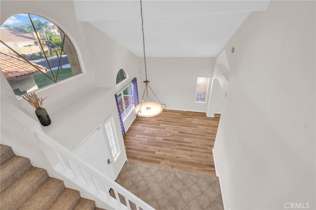 9253 Sunridge Drive Riverside, CA 92508 - Photo 23 of 54 a view of a livingroom with wooden floor and a staircase