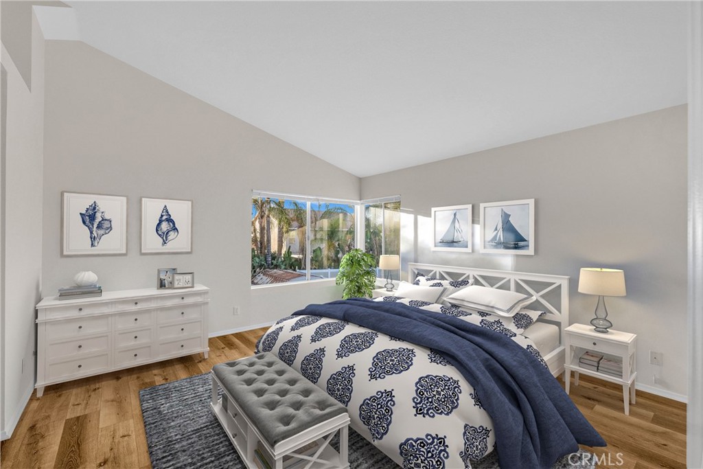 9253 Sunridge Drive Riverside, CA 92508 - Photo 24 of 54 a bedroom with a bed and wooden floor