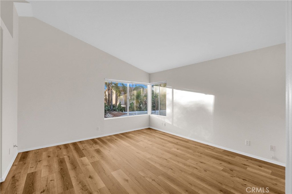 9253 Sunridge Drive Riverside, CA 92508 - Photo 25 of 54 a view of an empty room with wooden floor and a window