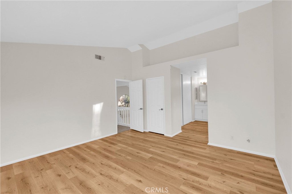 9253 Sunridge Drive Riverside, CA 92508 - Photo 27 of 54 a bedroom with a bed and a lamp