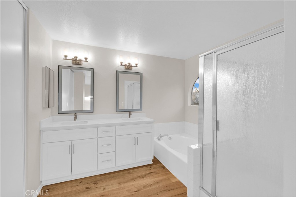 9253 Sunridge Drive Riverside, CA 92508 - Photo 28 of 54 a bathroom with a tub sink and mirror