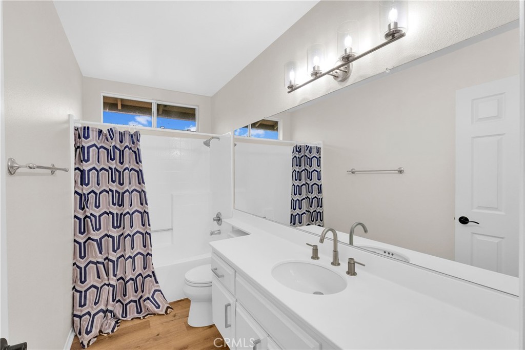 9253 Sunridge Drive Riverside, CA 92508 - Photo 34 of 54 a bathroom with a sink a toilet and shower